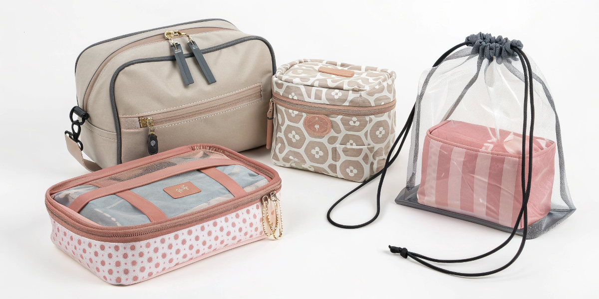 An assortment of different makeup bag styles: pouch, train case, drawstring, and clear PVC